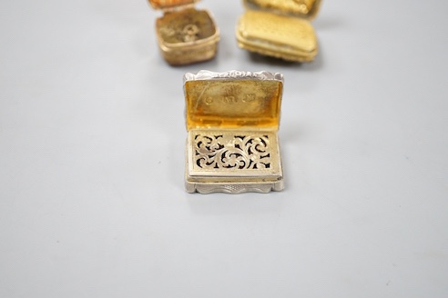 A Victorian engraved silver shaped rectangular vinaigrette, Alfred Taylor, Birmingham, 1850, 27mm and two other gilt metal vinaigrettes, one with inset agate lid.